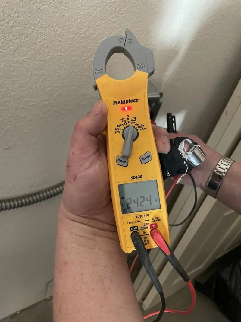Voltage testing with clamp meter during Electrical Installation Services in Douglas